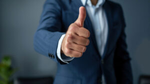 Businessman in a suit showing a thumbs up